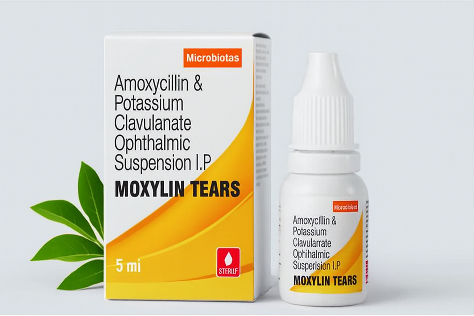 White bottle and box of Moxylin Tears ophthalmic suspension with orange-yellow design and green leaves on a light background.